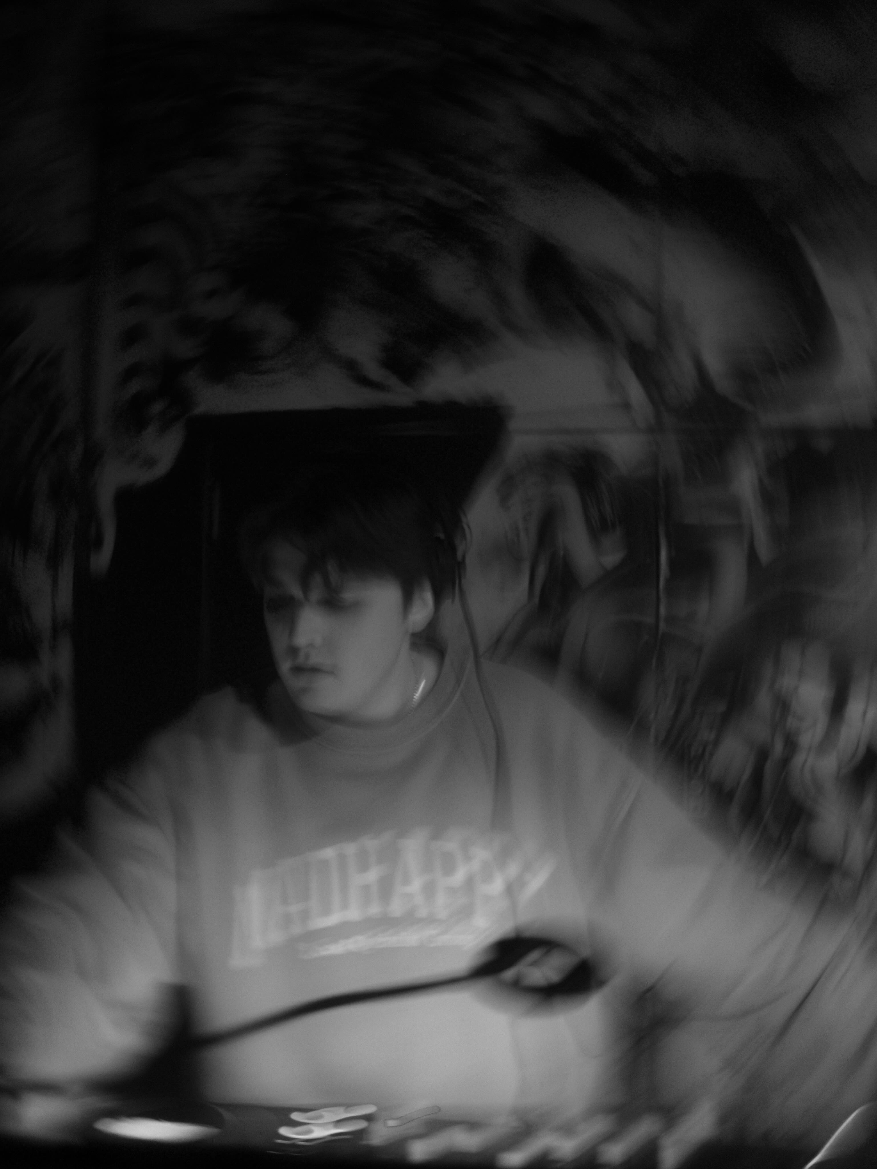 Kaden Meza DJing, photographed in black and white